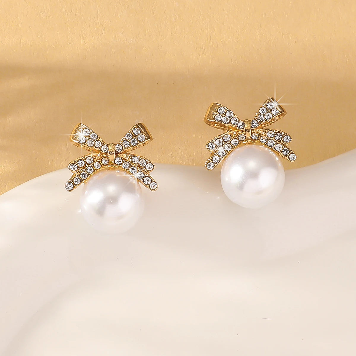 Silver Needle Bow Studded With Diamond Pearl Earrings